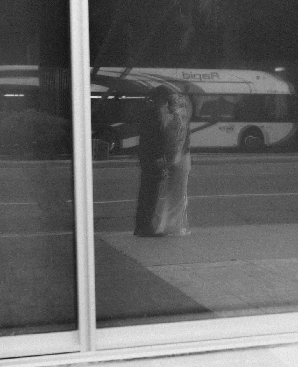 Leslie and Richard reflected in a downtown San Diego storefront window.
