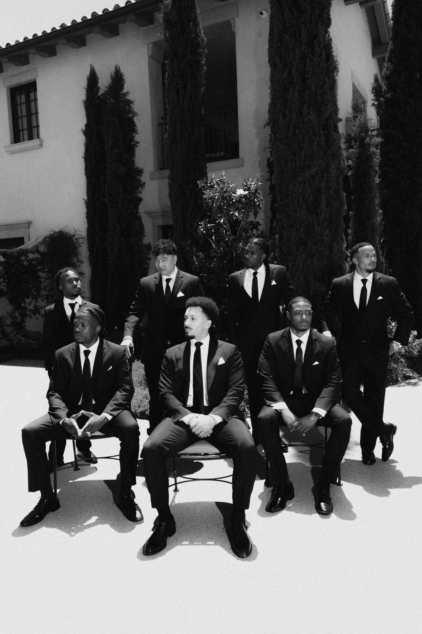 The wedding party in front of Monserate Winery's cypress-lined architecture.