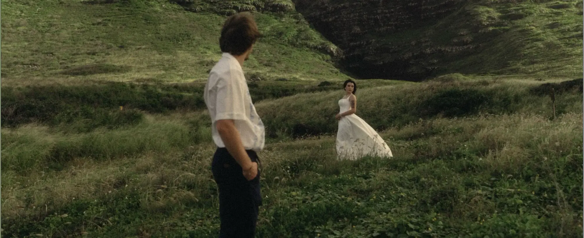 A couple meeting across a green field